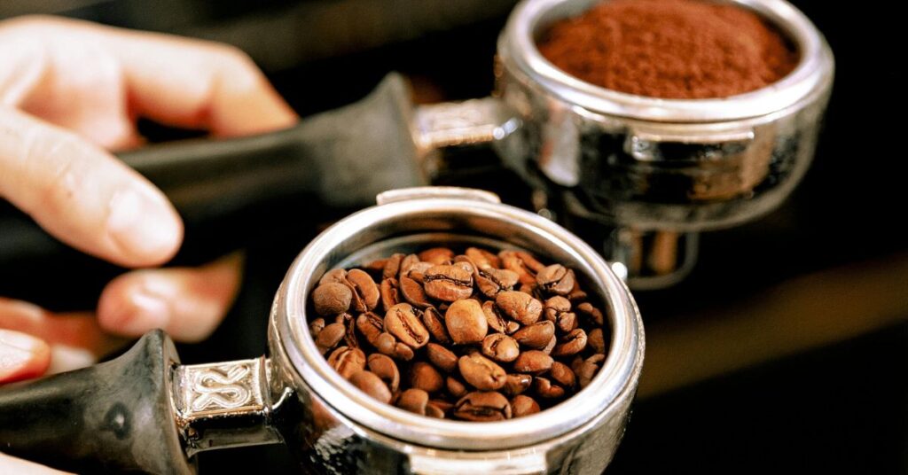Barista Holding Portafilter with Coffee Beans