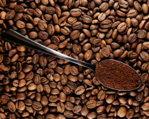Coffee Beans with Spoon of Ground Coffee