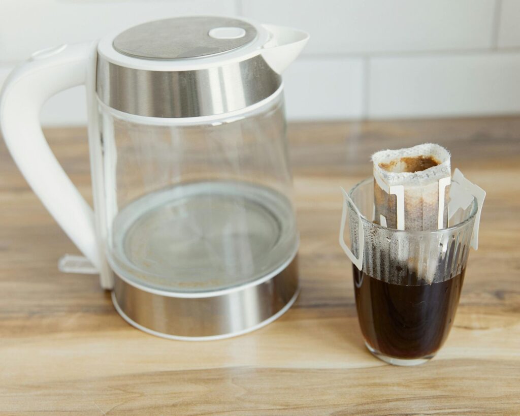 Glass Kettle and Coffee on a Wooden Table