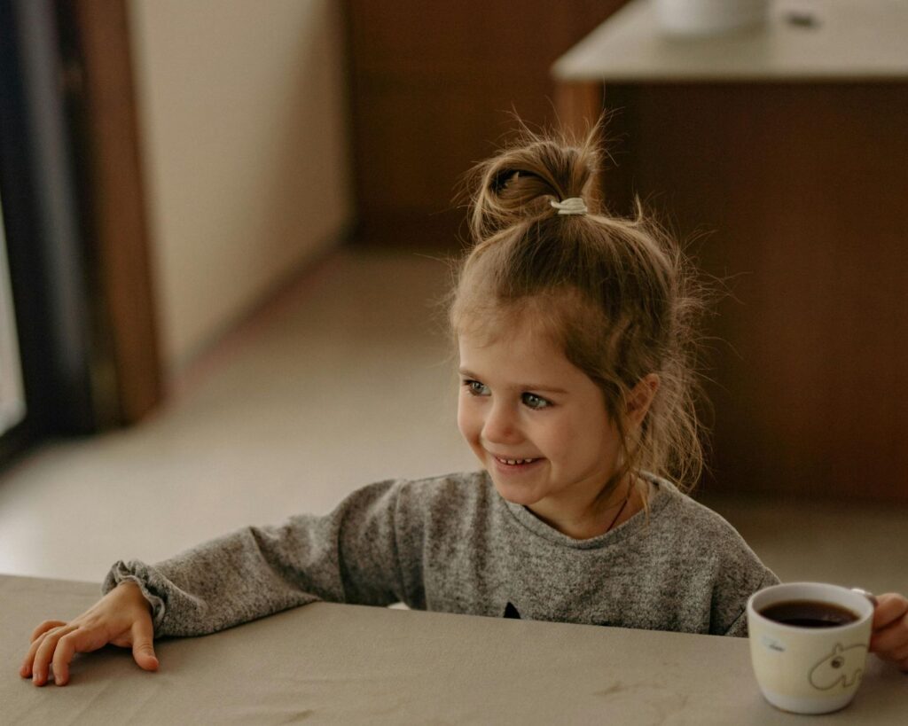 Girl Smiling While Holding Tea Cup