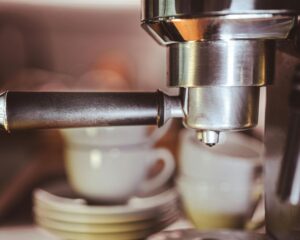 Close-up of an espresso machine with metal portafilter.