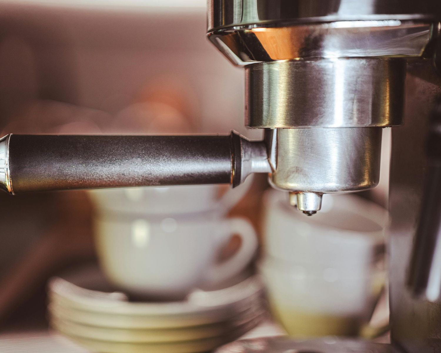 Close-up of an espresso machine with metal portafilter.