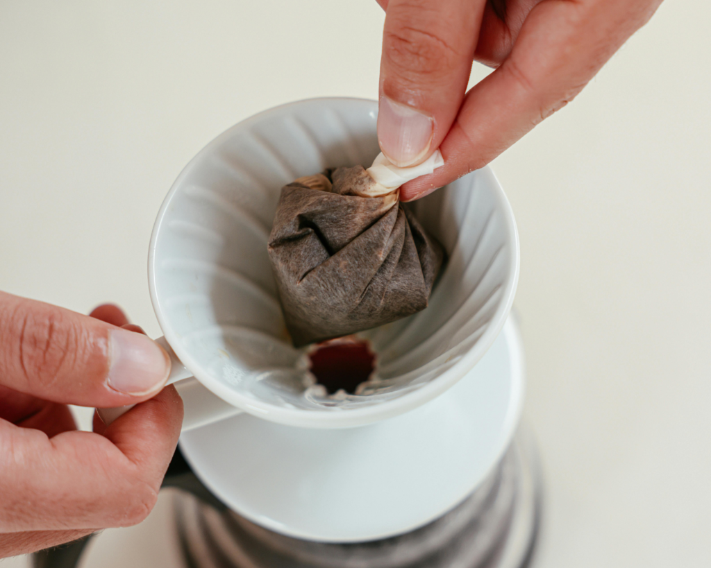 A Close-Up Shot of a Person Making Coffee