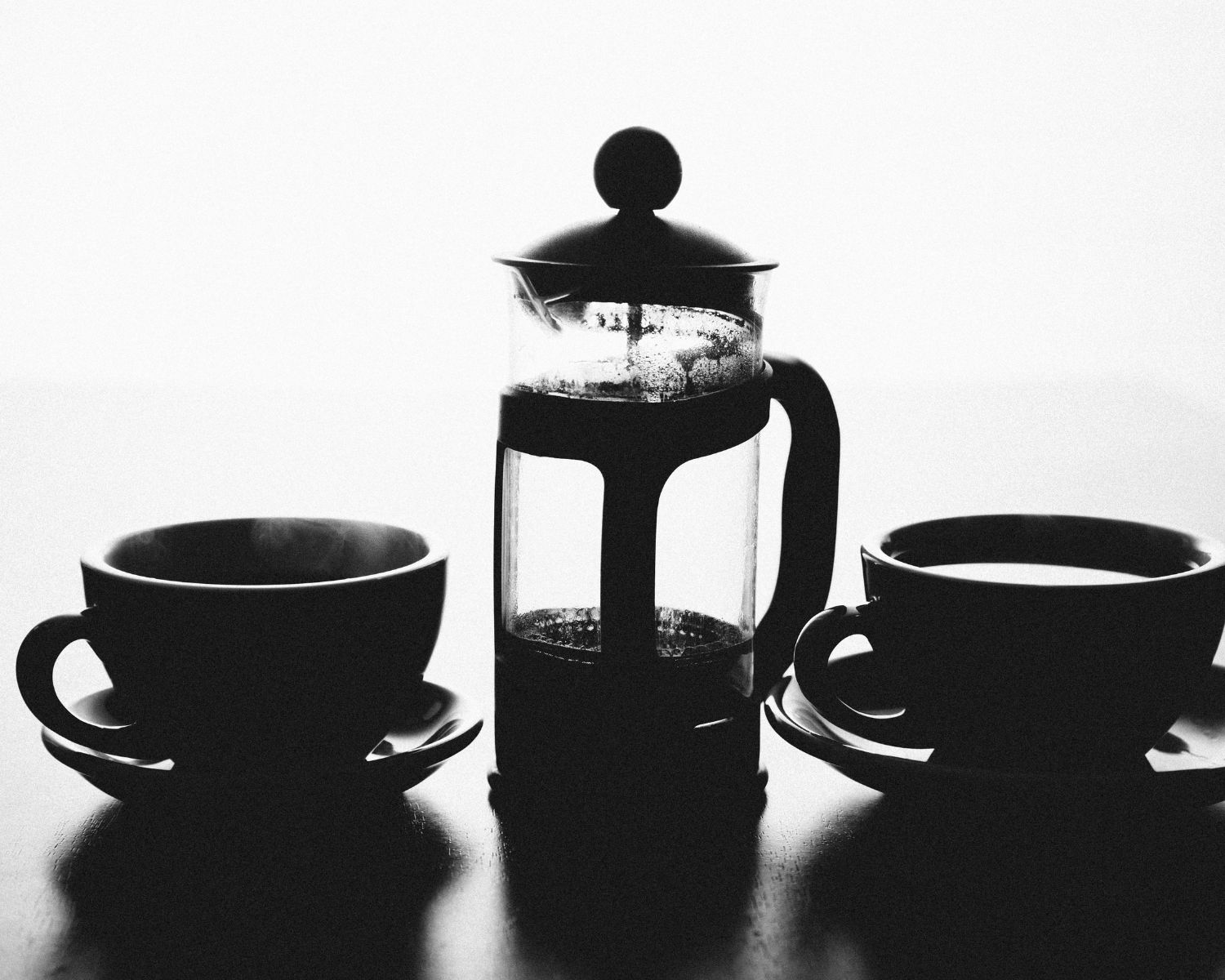 French press and two cups of coffee