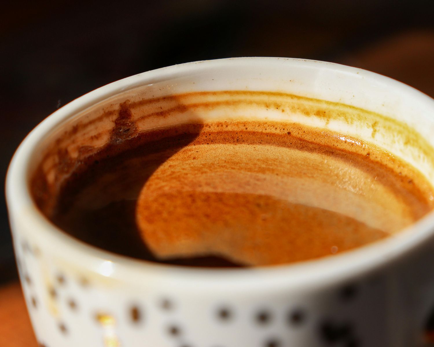 Close-up of espresso with crema in dotted cup.
