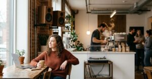 Woman relaxing to music in a coffee shop.