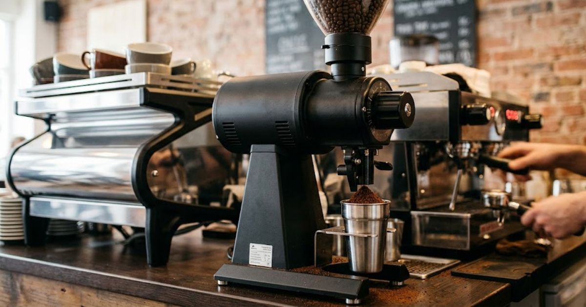 Commercial coffee grinder on a cafe counter.